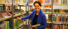 Gezeigt wird eine Mitarbeiterin der Bibliothek
