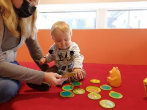 Kleinkind spielt Ein Kleinkind spielt mit seiner Mutter in der Kinderbibliothek