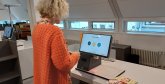 Eine Kundin steht vor einem Selbstverbucher